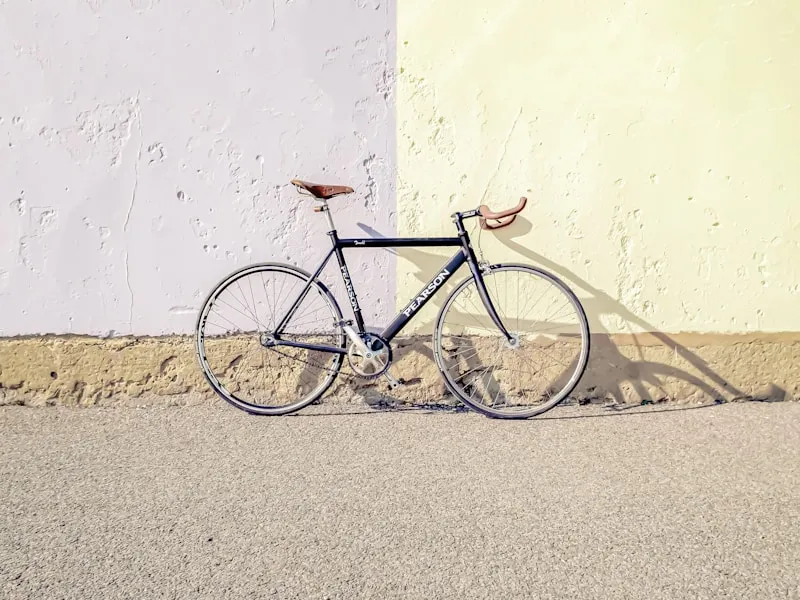 Garden cart loaded with plants and soil near a flower bed