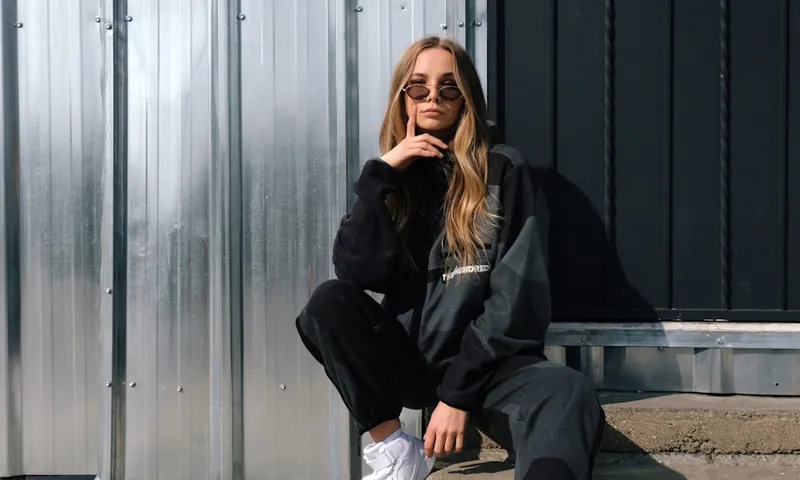 Person kneeling in garden tending to plants on a sunny day